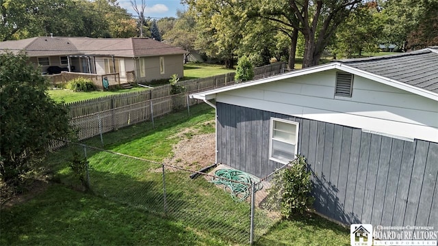 view of side of home with a lawn