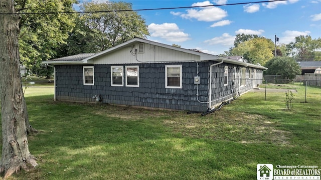 view of side of property with a lawn