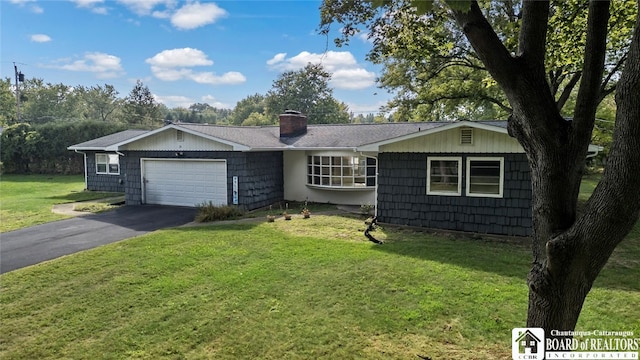 ranch-style home with a front lawn and a garage