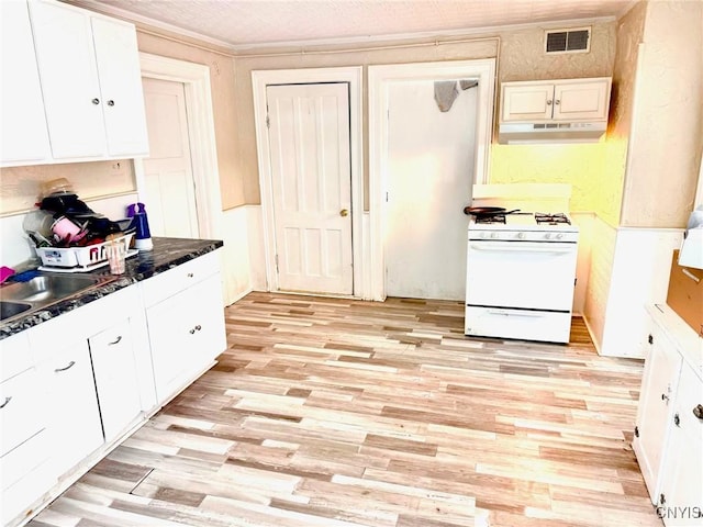 kitchen with white cabinetry, sink, light wood-type flooring, and white gas range oven