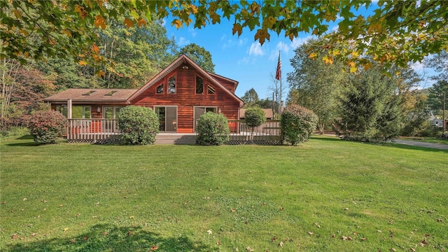 cabin featuring a front lawn