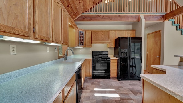 kitchen with black appliances, vaulted ceiling, and sink