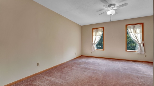 carpeted spare room with ceiling fan