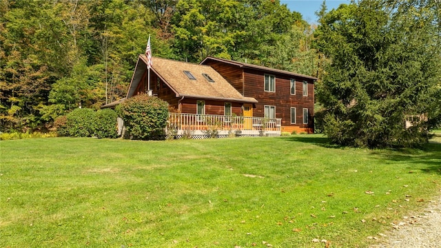 rear view of house featuring a lawn