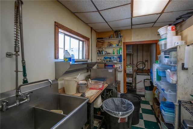 interior space featuring a paneled ceiling and sink