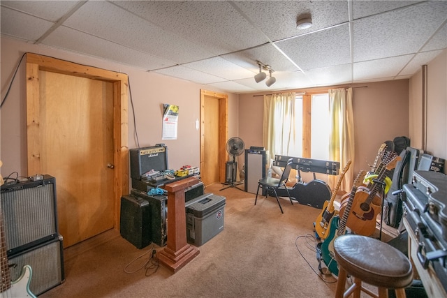 miscellaneous room featuring a paneled ceiling and carpet