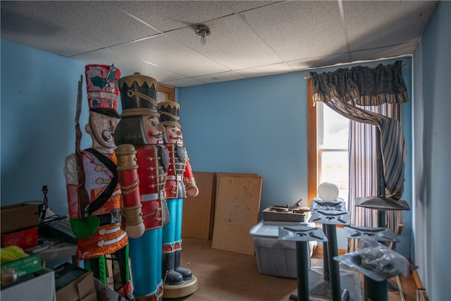 miscellaneous room with carpet flooring and a paneled ceiling