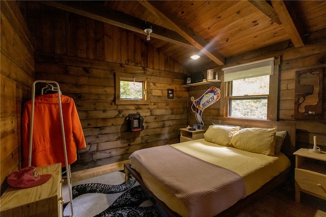 bedroom with multiple windows, wood walls, lofted ceiling with beams, and wood-type flooring