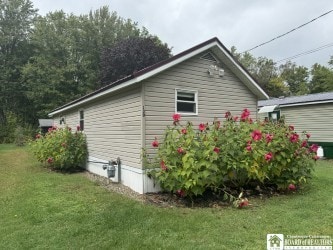 view of side of property with a lawn