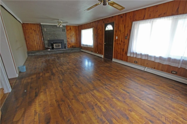 unfurnished living room featuring a baseboard radiator, dark wood-type flooring, ceiling fan, and a brick fireplace