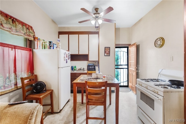 kitchen with white cabinets, white appliances, and ceiling fan