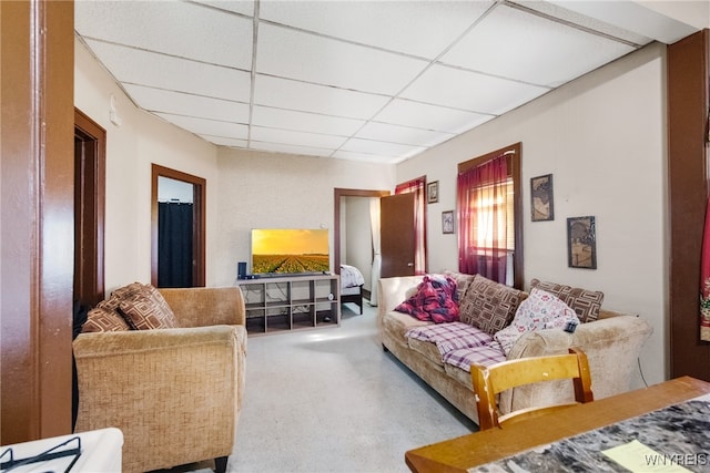 living room with a paneled ceiling