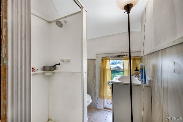 bathroom with a shower, tile patterned flooring, vanity, and toilet