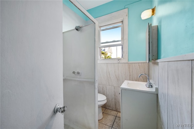 bathroom featuring tile walls, tile patterned flooring, vanity, and toilet