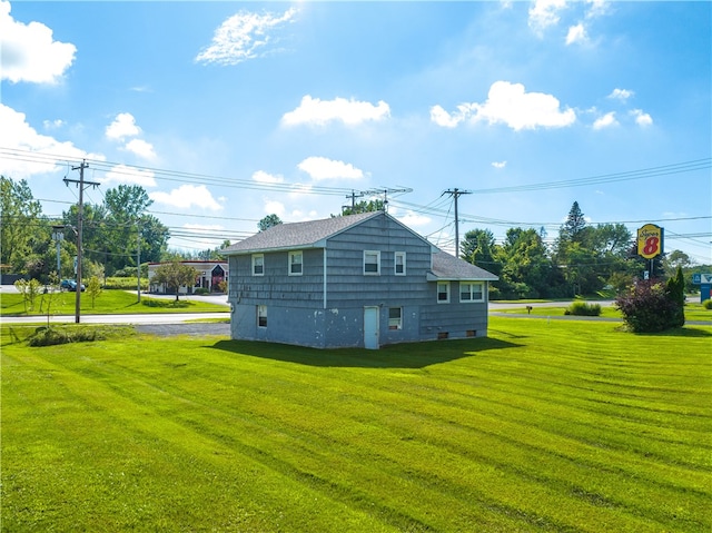 back of property with a lawn