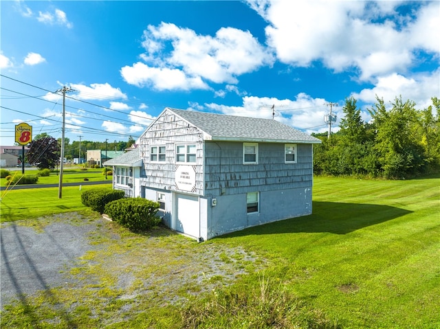 view of side of home with a lawn