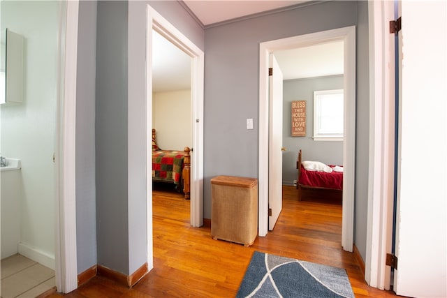 hallway with hardwood / wood-style flooring