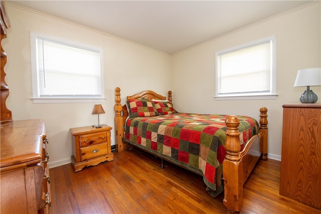 bedroom with crown molding and dark hardwood / wood-style floors