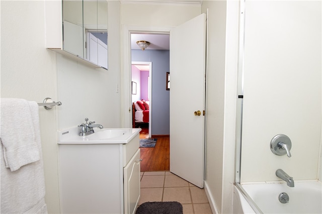 bathroom with tile patterned flooring, vanity, and shower / bath combination