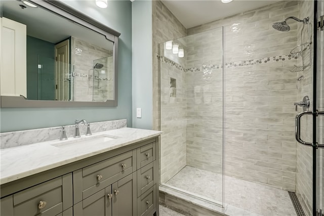 bathroom featuring walk in shower and vanity