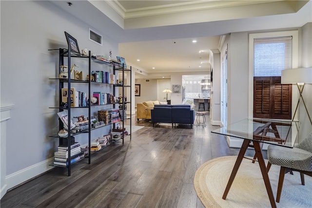 interior space with ornamental molding and hardwood / wood-style floors