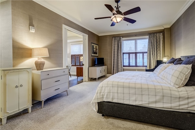 carpeted bedroom with ceiling fan and ornamental molding