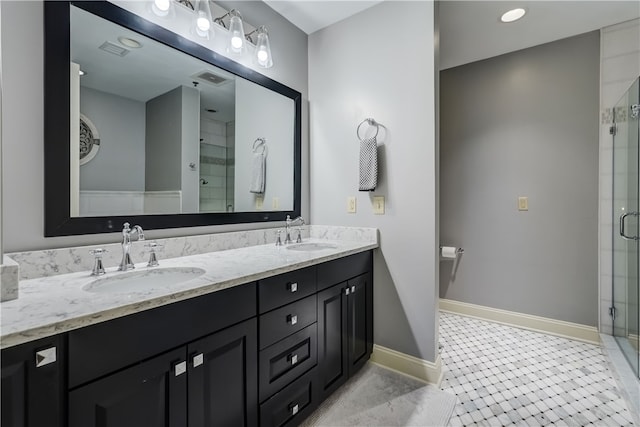 bathroom with tile patterned flooring, a shower with door, and vanity