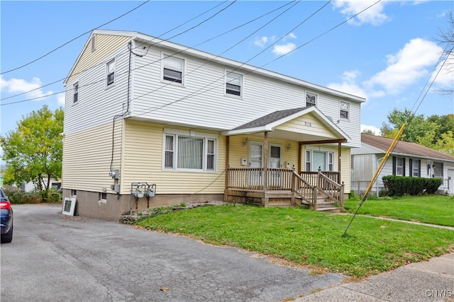 view of front of home with a porch and a front yard