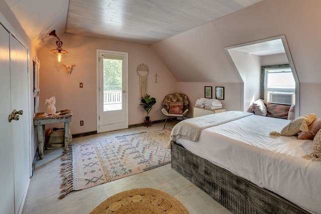 bedroom featuring cooling unit, lofted ceiling, multiple windows, and access to outside