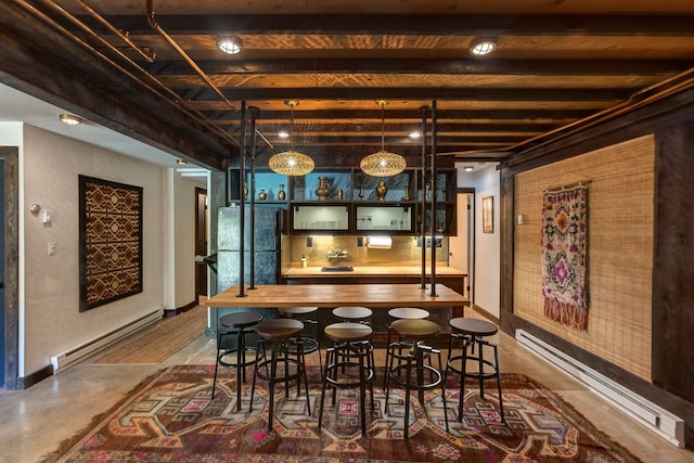 dining room with a baseboard heating unit, indoor bar, and beamed ceiling