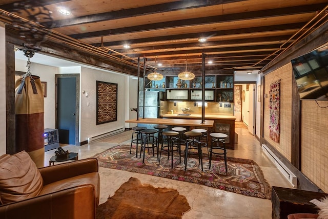 dining area featuring beamed ceiling, baseboard heating, and bar