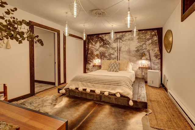 bedroom with wood-type flooring and baseboard heating