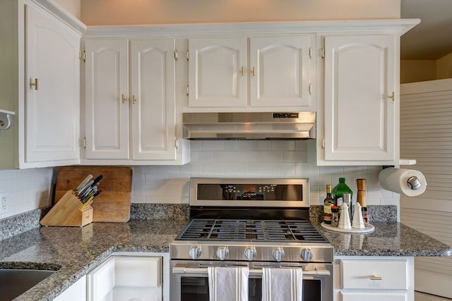 kitchen with decorative backsplash, white cabinetry, stone counters, and double oven range