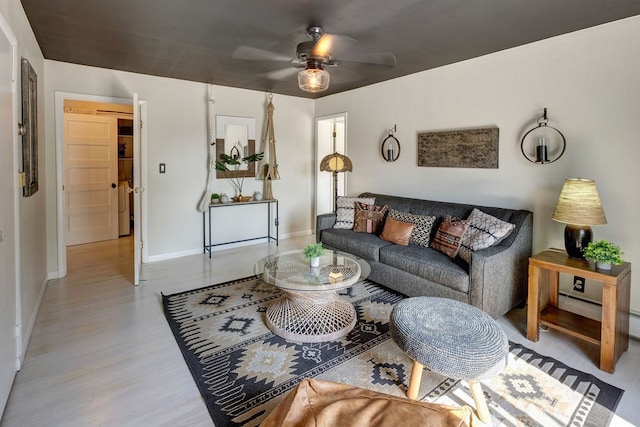 living room featuring light hardwood / wood-style floors and ceiling fan