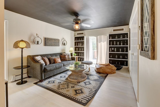 living room with light hardwood / wood-style flooring, ceiling fan, and a baseboard radiator