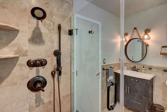 bathroom with vanity, tile walls, and a tile shower