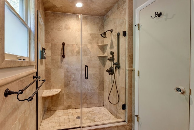 bathroom with a shower with door