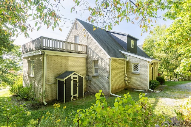 back of house featuring a balcony