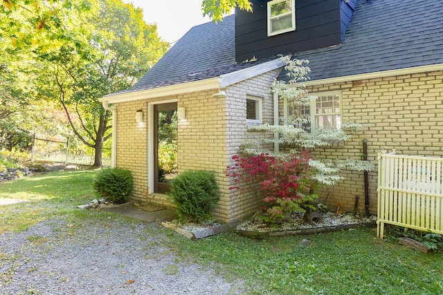 view of side of home with a lawn