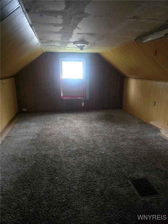 additional living space featuring lofted ceiling and carpet flooring