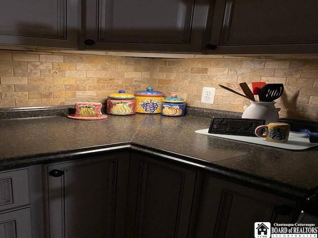 kitchen featuring dark brown cabinetry and decorative backsplash