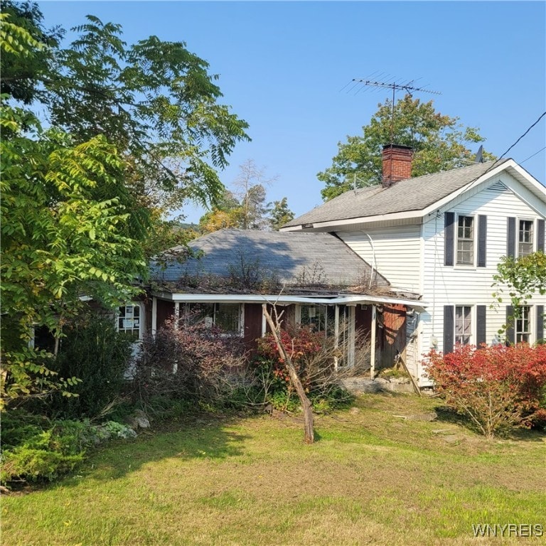 rear view of property with a yard