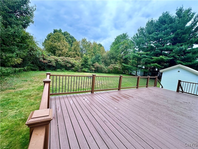 wooden terrace with a lawn