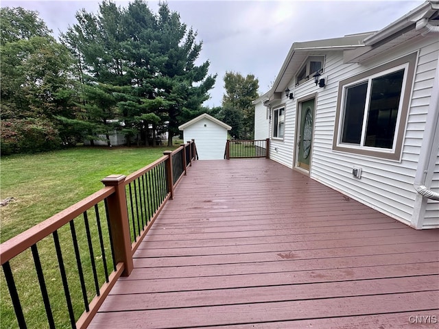 wooden terrace featuring a lawn