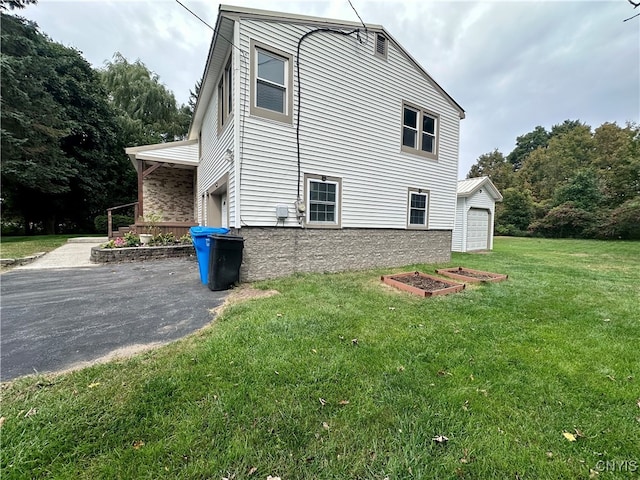 view of side of property with a lawn and a garage