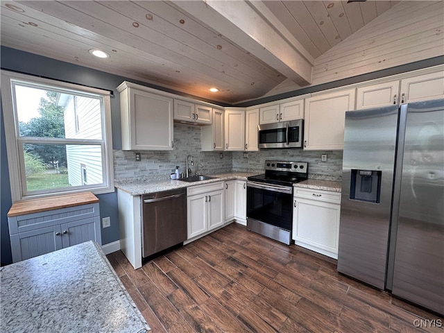 kitchen with stainless steel appliances, lofted ceiling, white cabinets, and sink