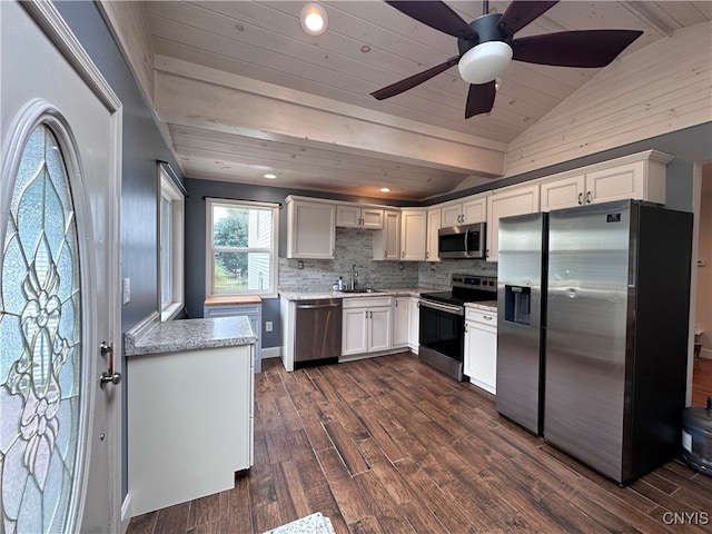 kitchen featuring white cabinetry, dark wood-type flooring, stainless steel appliances, lofted ceiling, and ceiling fan