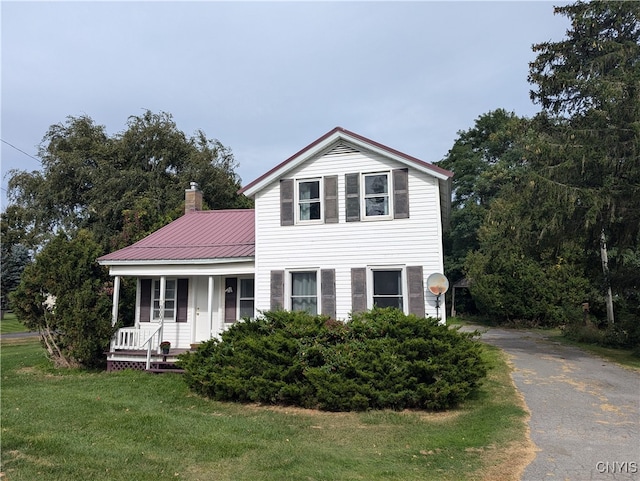 view of front facade with a front yard and a porch