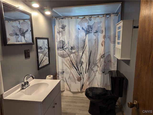 bathroom featuring a shower with curtain, vanity, hardwood / wood-style floors, and toilet