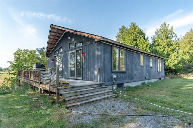 view of property exterior featuring a deck and a yard